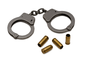 Handcuffs and spent bullet casings representing crime and suspense