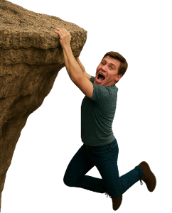 Terrified male hanging from a cliff, representing danger and suspense