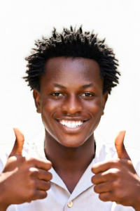 Handsome young man thrusting two thumbs up